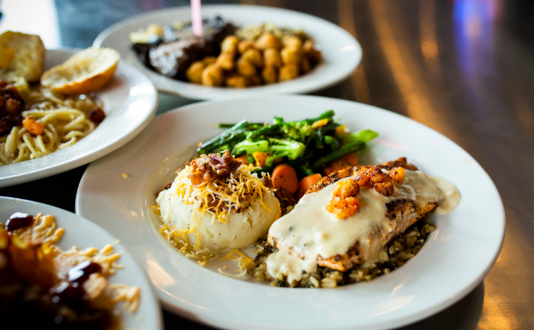 Various plates of food prepared by House Divided Restaurant & Sports Grill